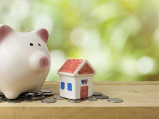 Ceramic Piggy Bank And House On A Shelf With Coins Gettyimages 951812406 1200w 628h.jpg