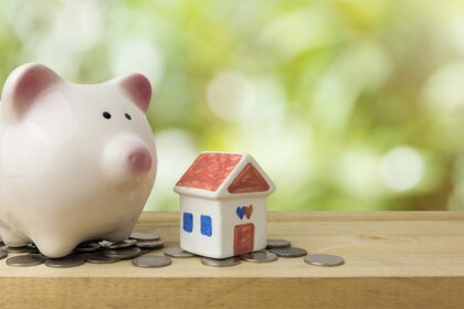 Ceramic Piggy Bank And House On A Shelf With Coins Gettyimages 951812406 1200w 628h.jpg