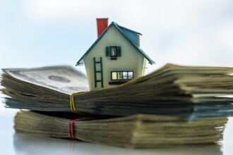 Toy House On Stack Of Paper Money Fotolia 121386700 1200w 628h.jpg